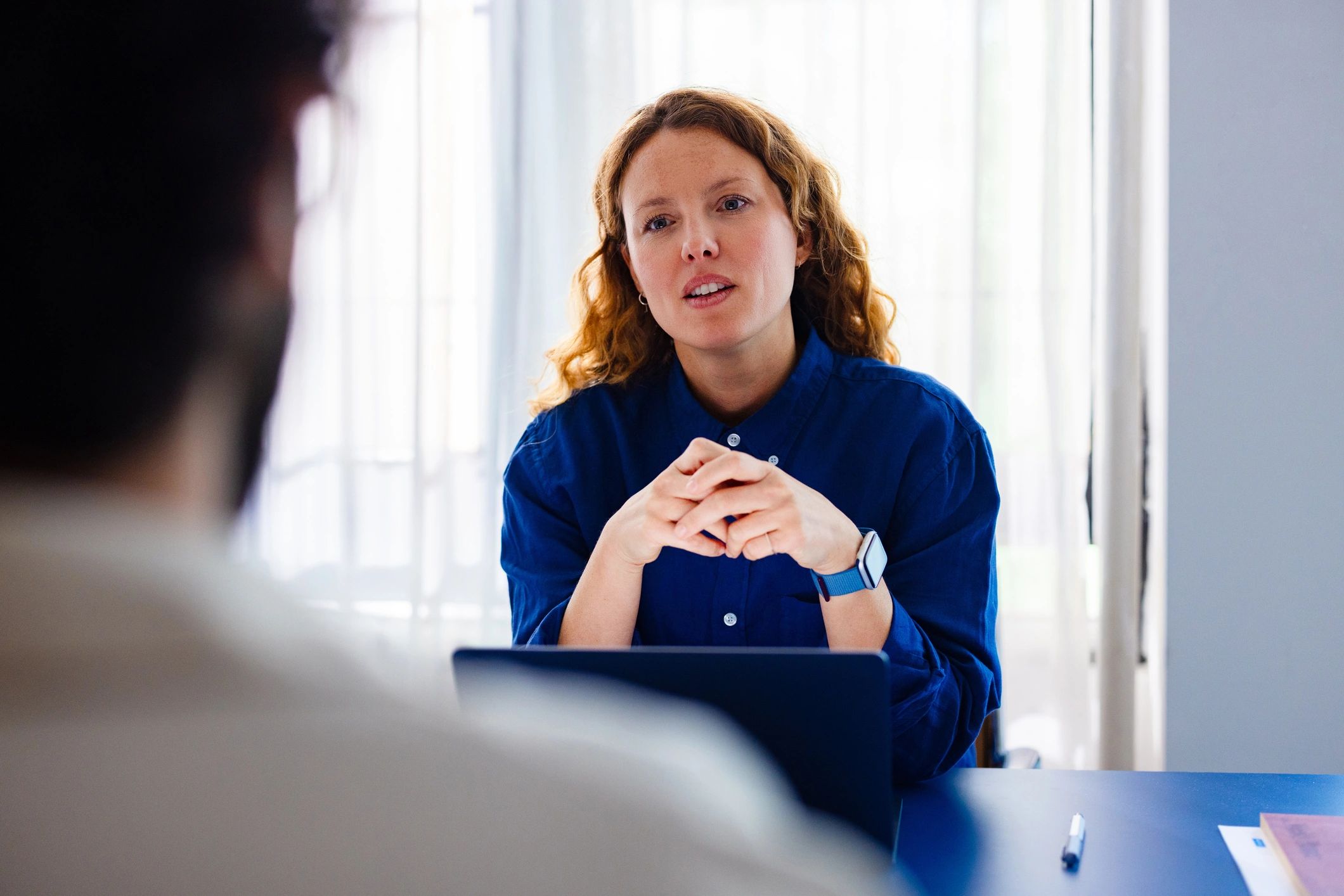 Professional recruiter conducting an interview at an office desk